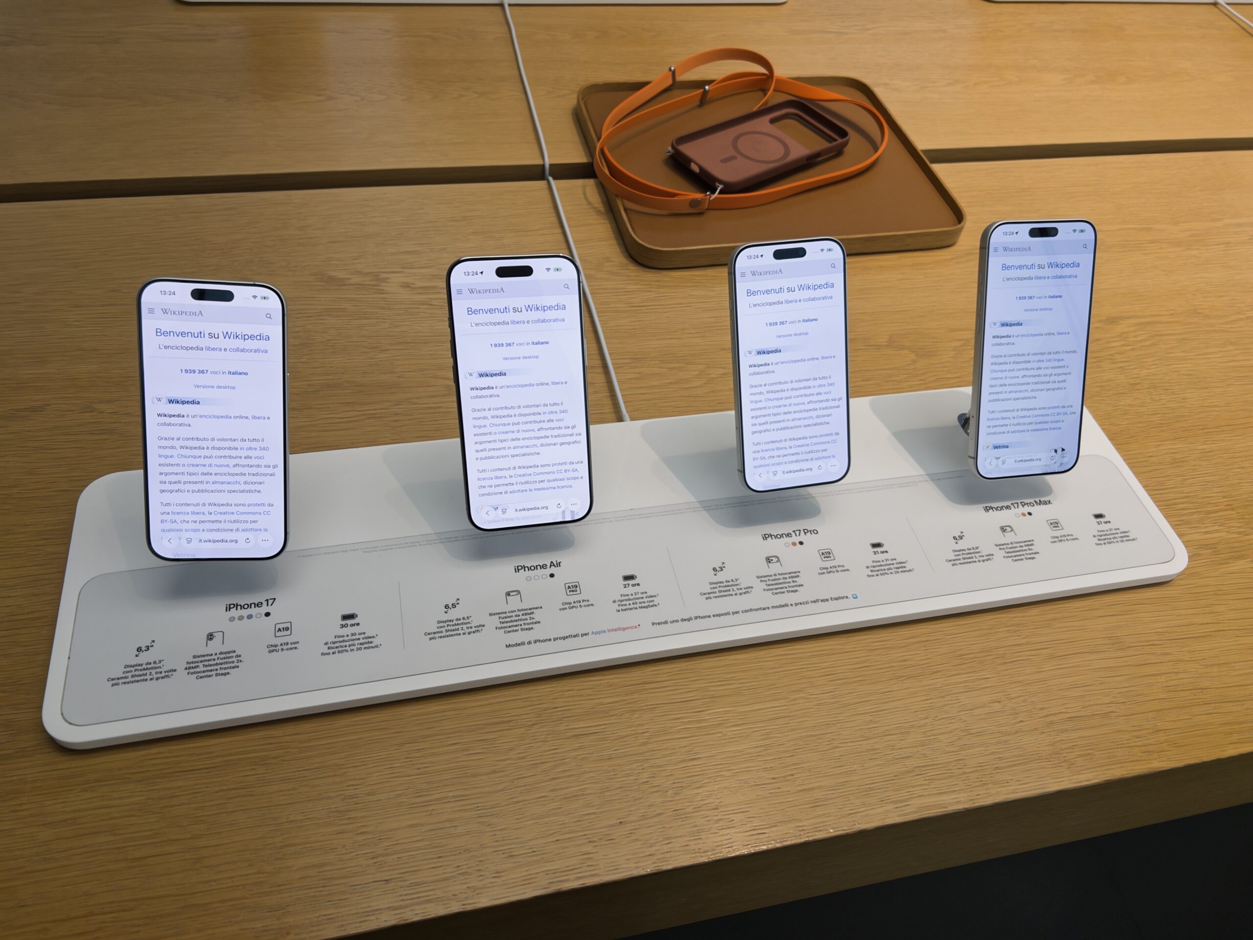Row of current iPhone models on display, including the camera and Photos apps on the home screen