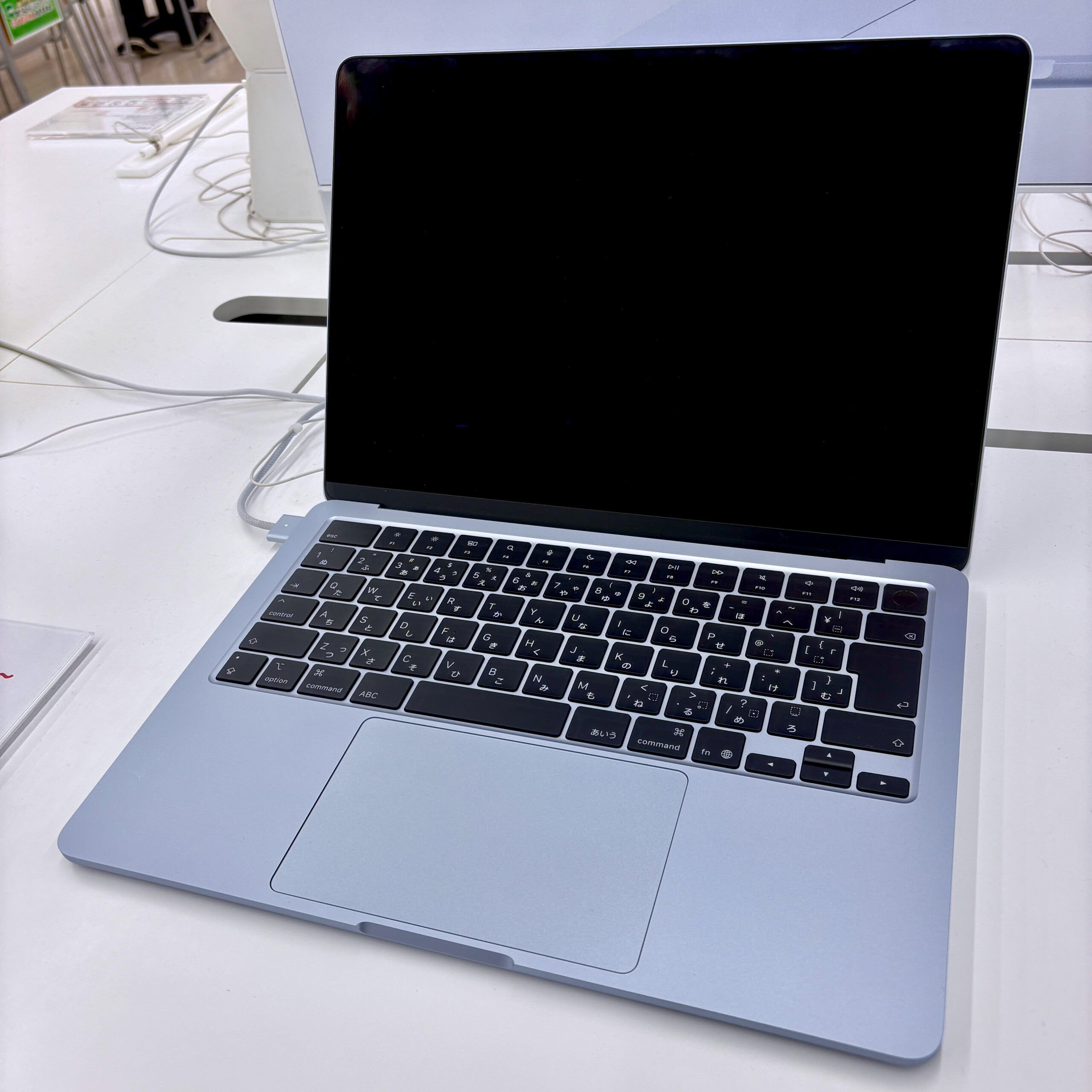Modern laptop on a store display, the kind of device that ships with battery care or conservation mode software built in